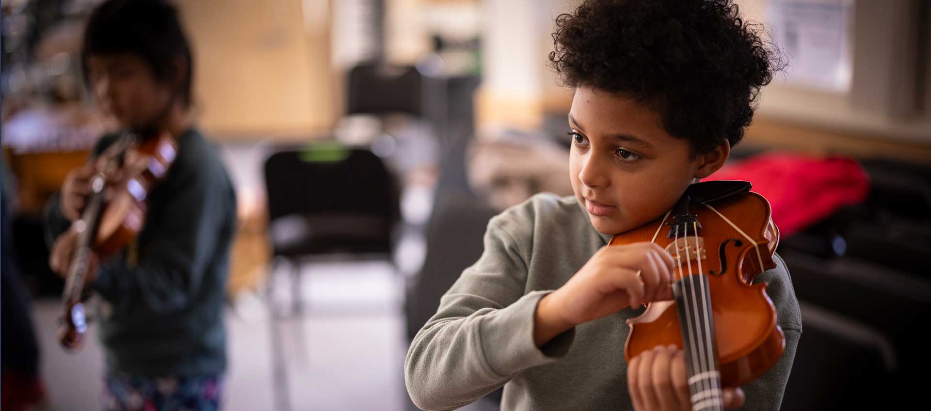 A student learns the proper position and pizzicato