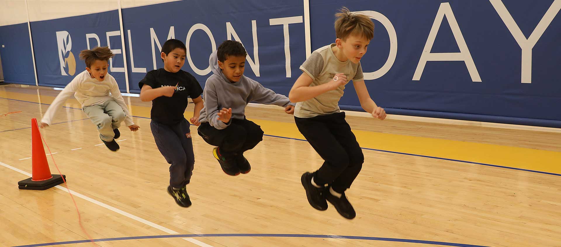 Four third graders jump rope together in PE class