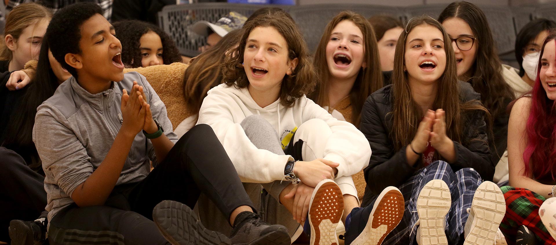 Several students sing at the winter send-off assembly