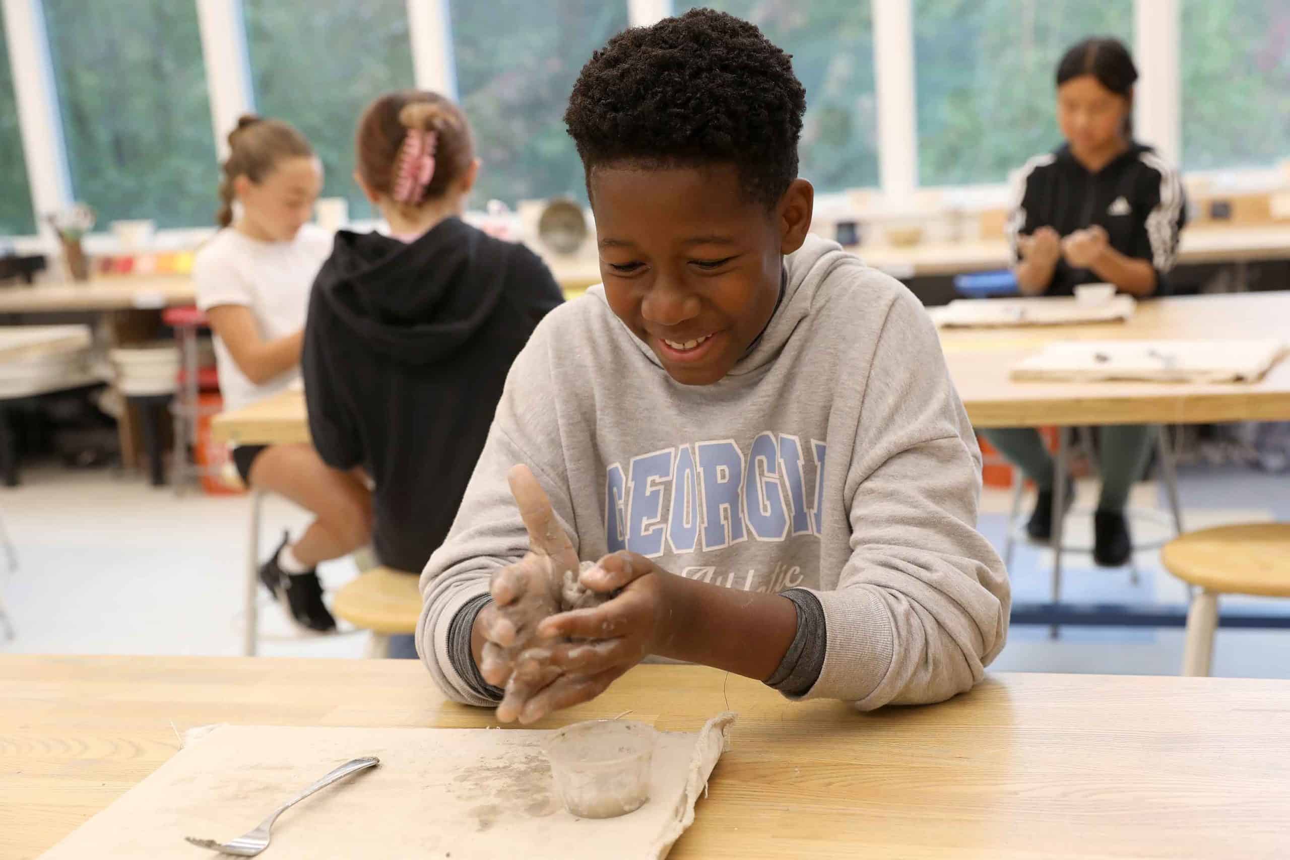 A student works on a hand-building clay project