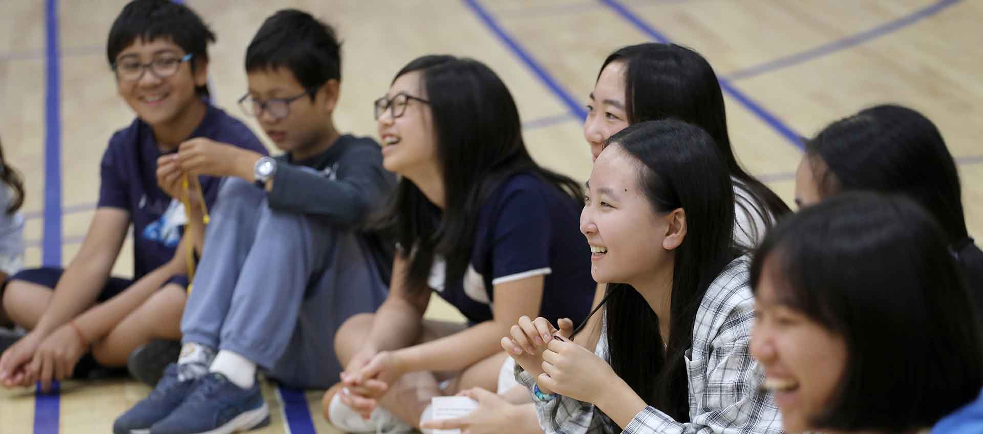 A group of students laugh together