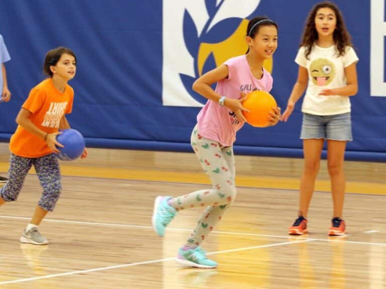 Three girls in the gymnasium during PE class