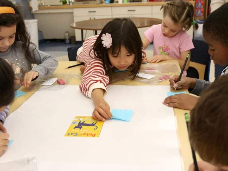 A group of first graders work on a literacy activity