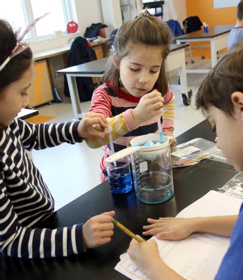First graders conduct an experiment about clouds
