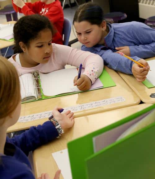 Three girls work on mathematics together