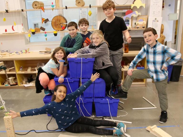 Fourth graders solve a pyramid design challenge in the woodworking studio