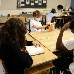 Middle School Students Seated and Reading Books at Belmont Day School