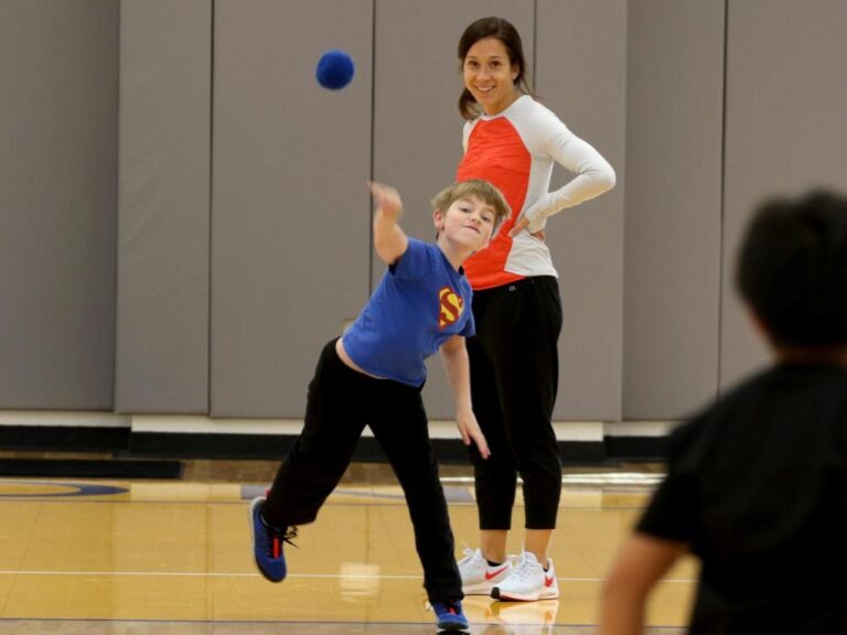 A boy tosses a ball in PE class