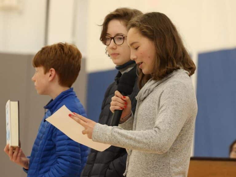 Two students present at sharing assembly