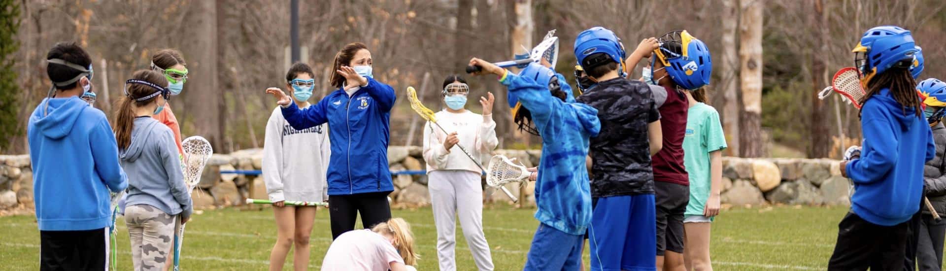 Abbey Nyland coaching middle school lacrosse players