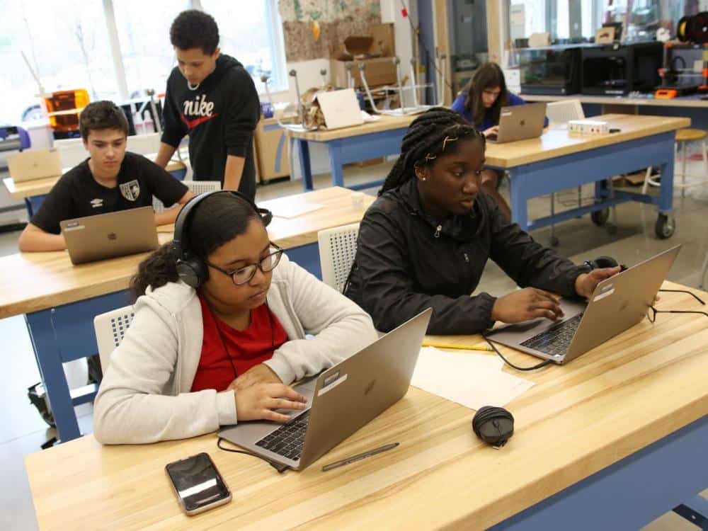 Four eighth graders work on projects during Capstone studio week at Belmont Day School