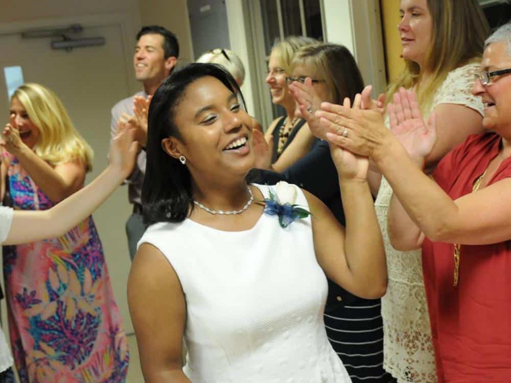 Faculty high-five a Belmont Day School graduate