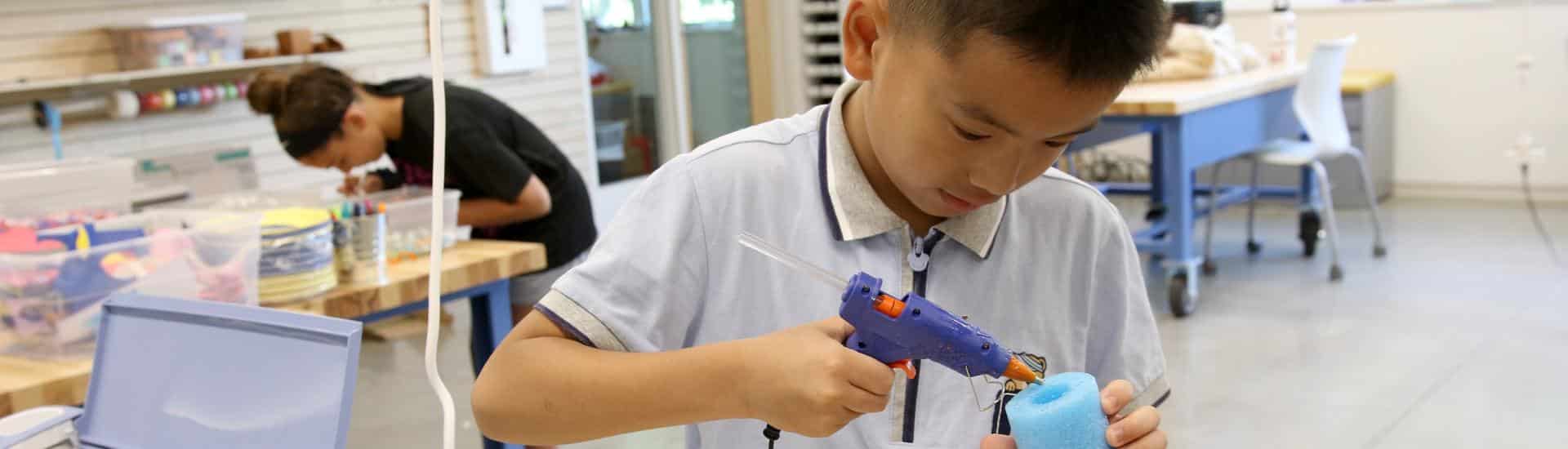 A boy works on a project in the IMPACT lab