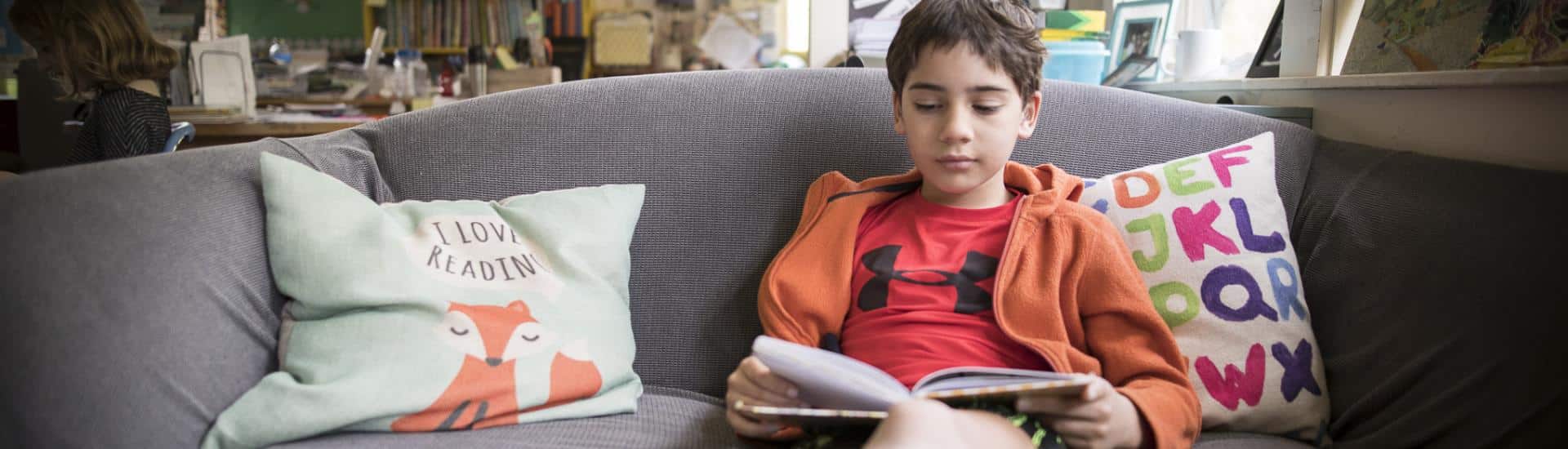 Boy reading on couch
