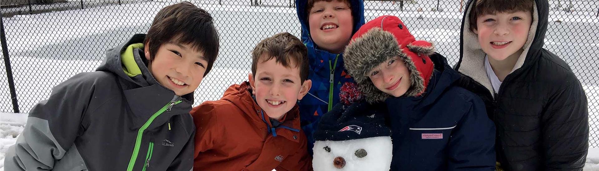 Five boys make a snowman