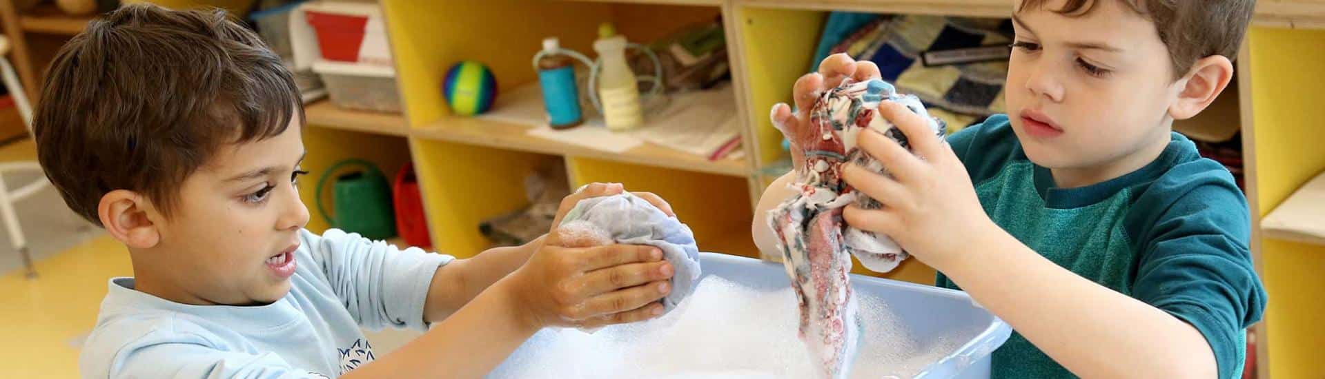 Two boys work on a felted object in the art studio
