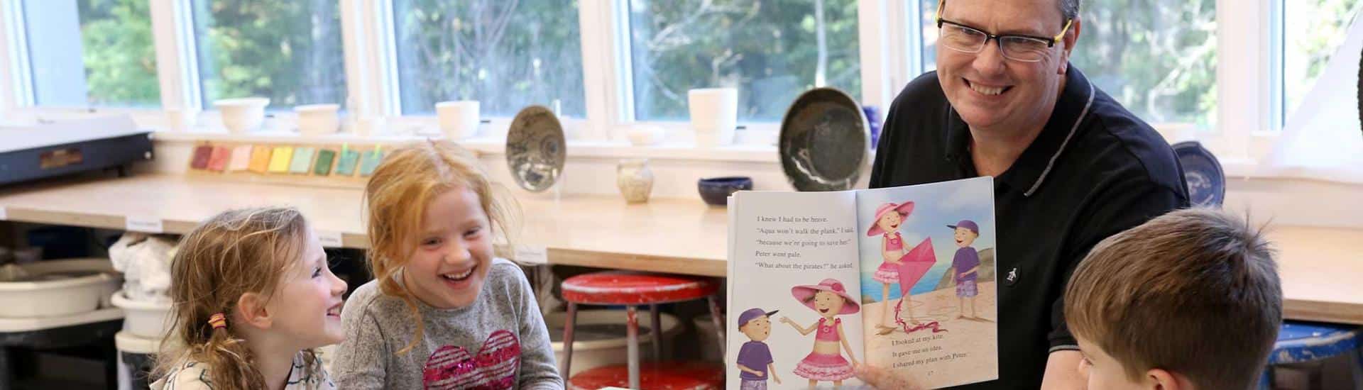 Enrichment teacher reading with students