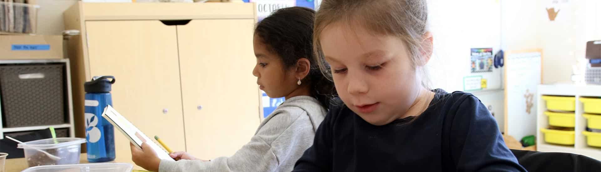 Two students work on their pumpkin observational drawings