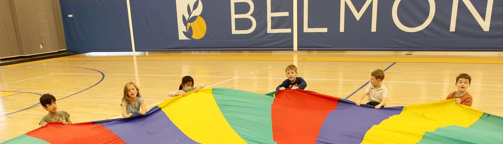 Students in the Barn gym doing a parachute game