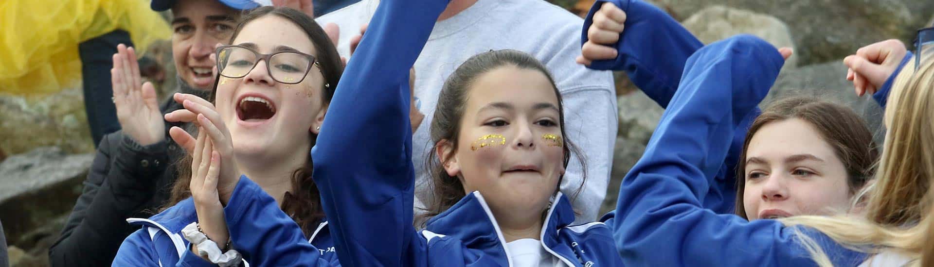 Students and parents cheer at the Spirit Day parade