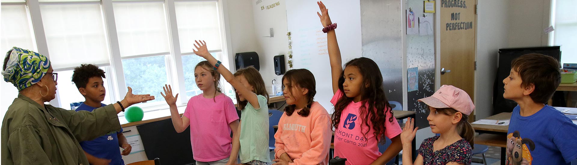 A Summer Spark teacher with a group of campers