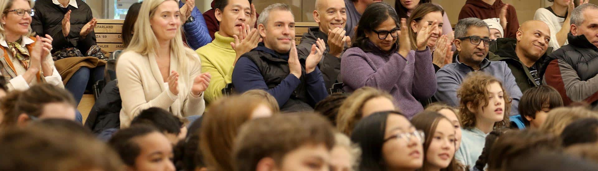 Parents applaud during the Thanksgiving Assembly