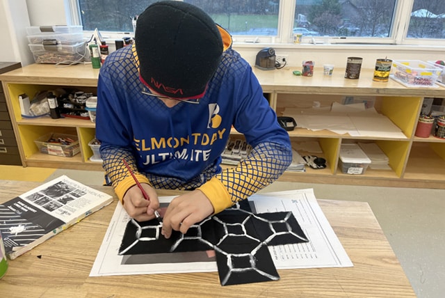 A student works on his soft sculpture project