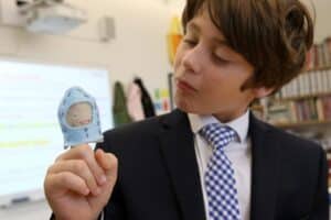 A student with his original finger puppet design