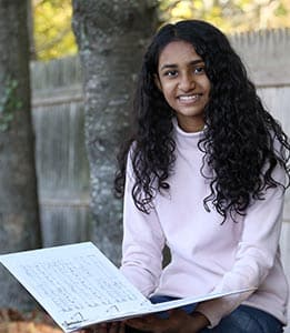 A member of the middle school chorus with her sheet music