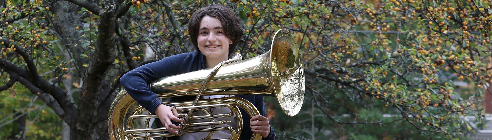 An eighth grade ensembles student with her tuba