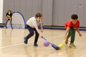 Two students race after the ball in PE class