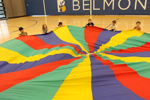 Pre-k students sail the parachute in PE class