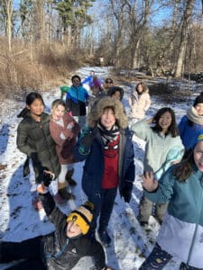 A group of students out on the trail in the woods