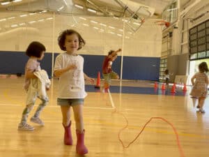 Pre-k students dash and hop in PE class