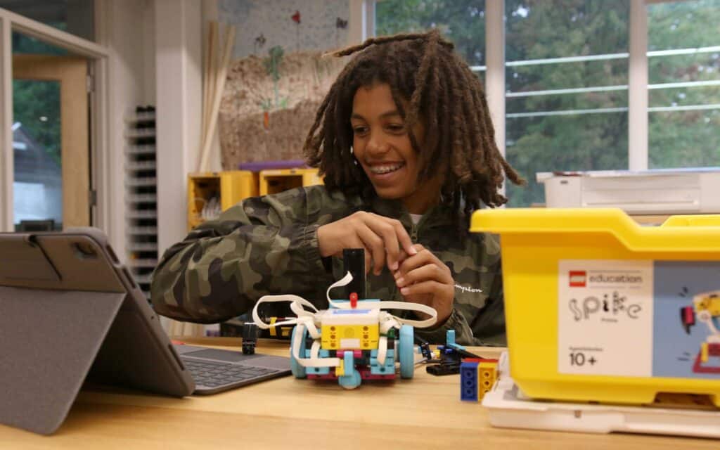 A student works on a LEGO robotics project in the IMPACT lab