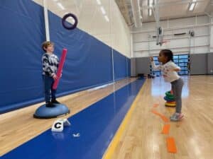 Two pre-k students in PE class