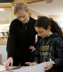 Isabel Moore '16 works with a student during her practicum in fourth grade