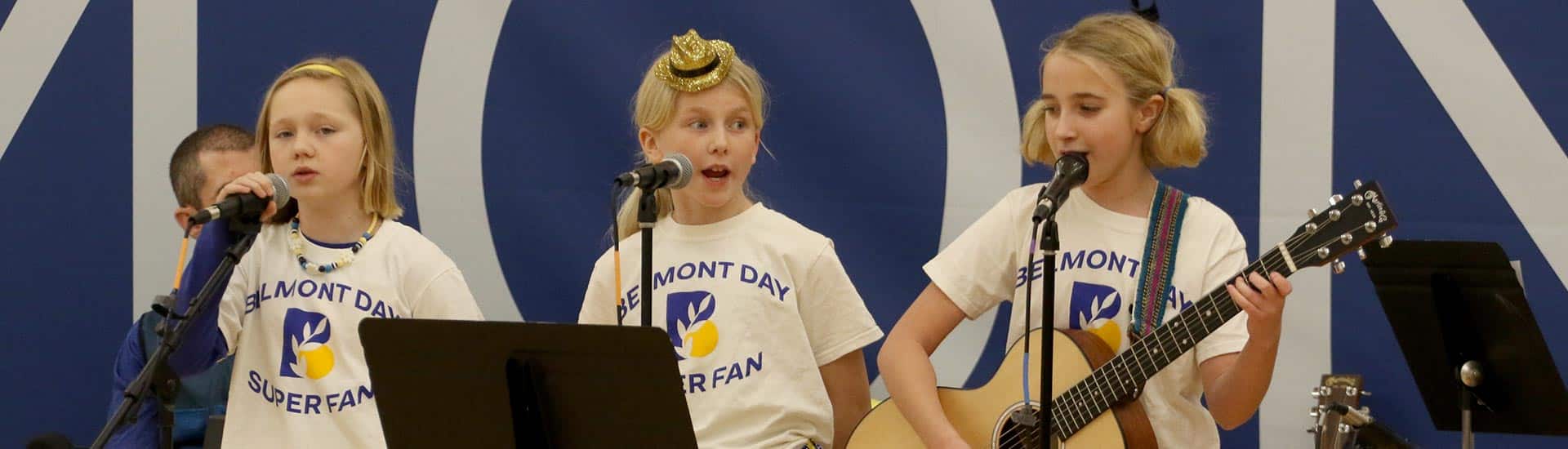 Three students perform at half-time in the Barn gym