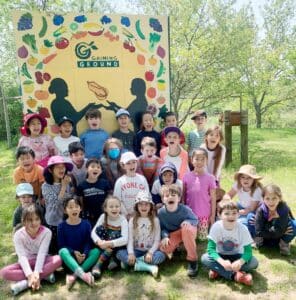 The second grade class poses together at Gaining Ground.