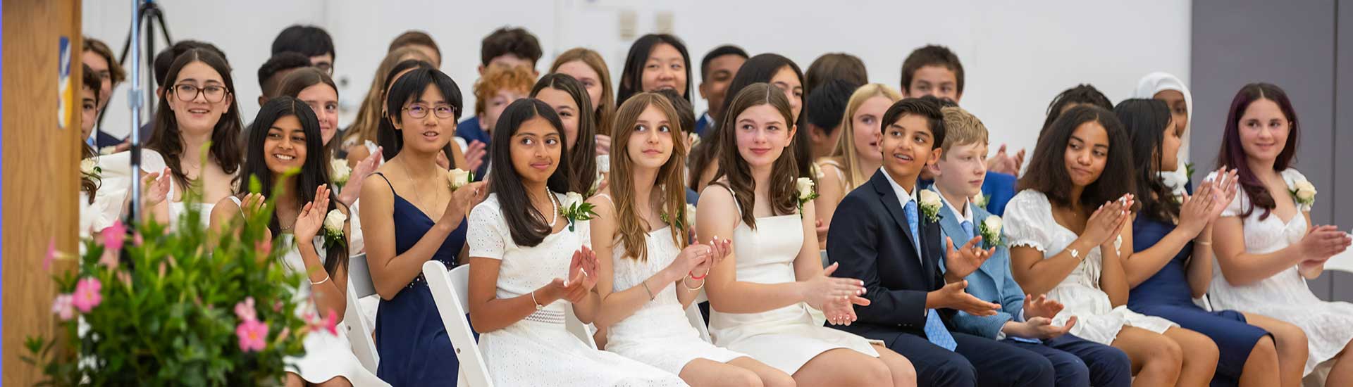 Students at their graduation ceremony applaud a speaker