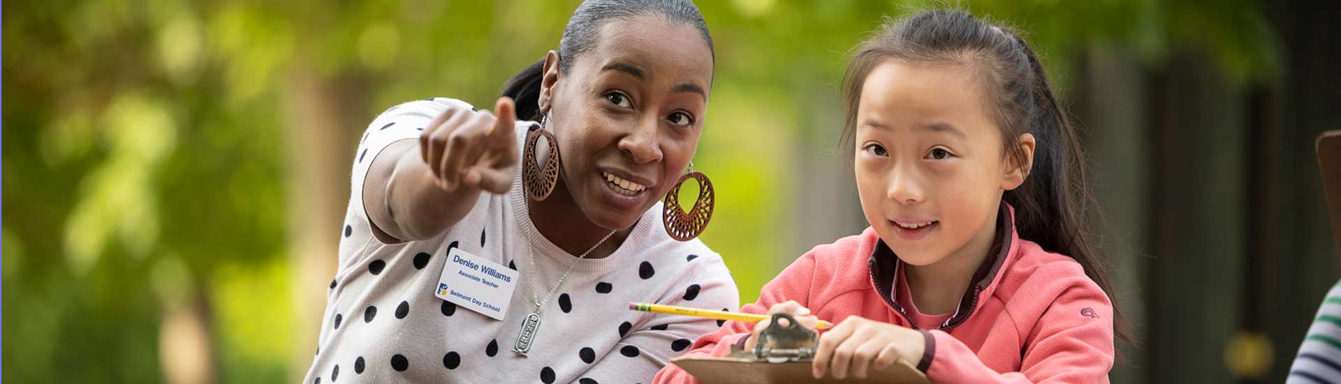 An associate teacher and a student observe nature together