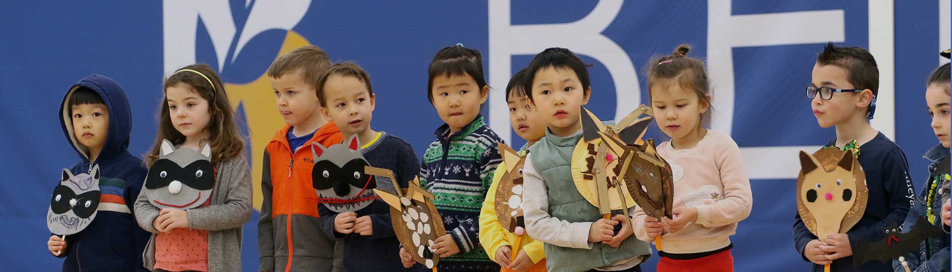 Pre-k students share their animal masks at assembly