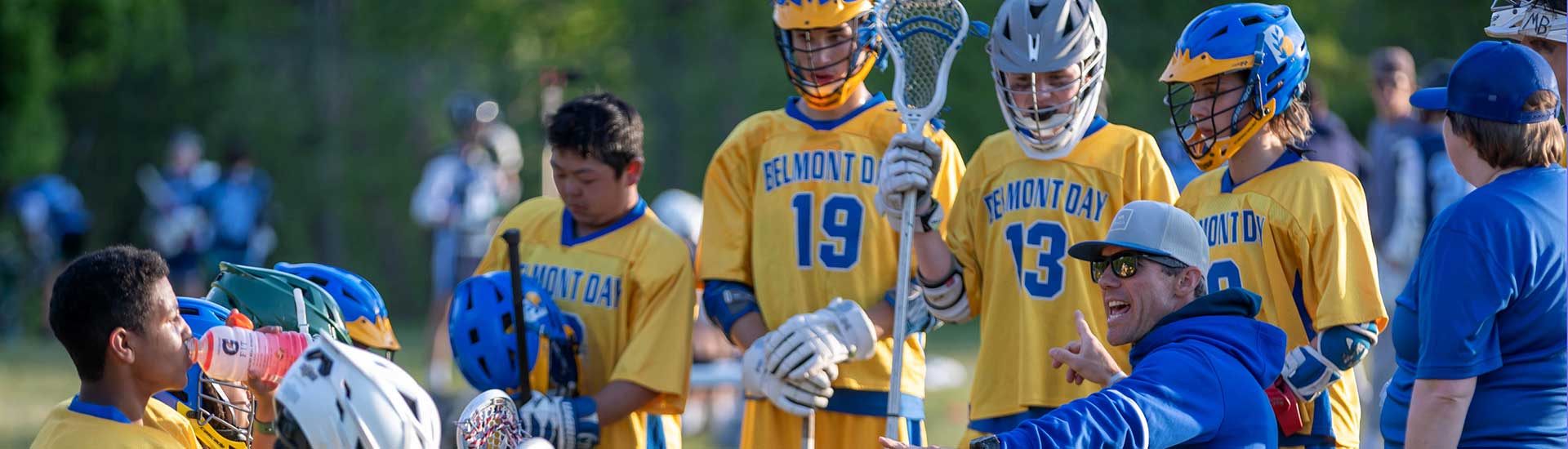 Coach O'Neill with lacrosse players before a game.