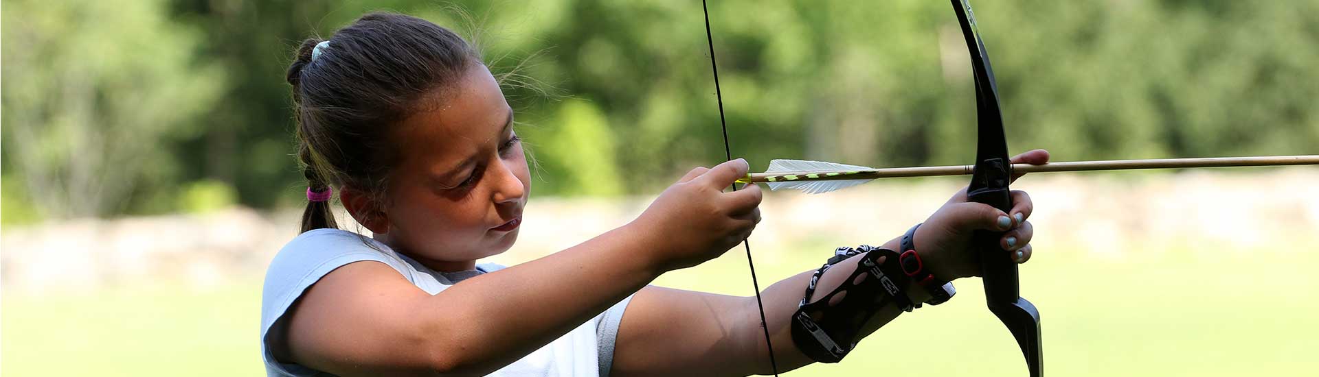 A camper takes aim on the archery pit
