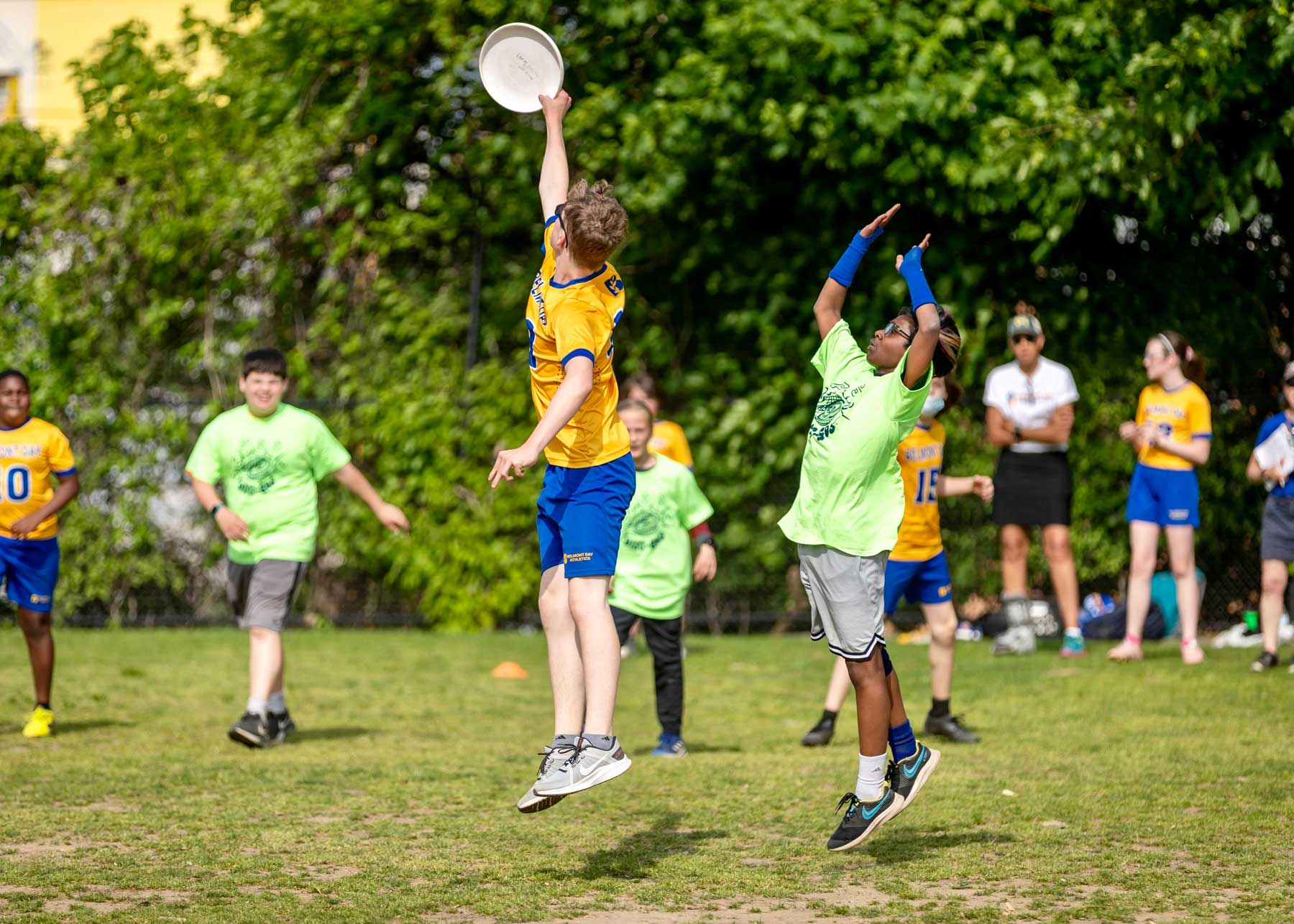 A student in the air catching an ultimate disk