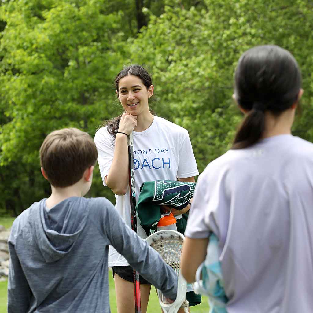 Alum Mia Biotti ’16 on the field with middle school students